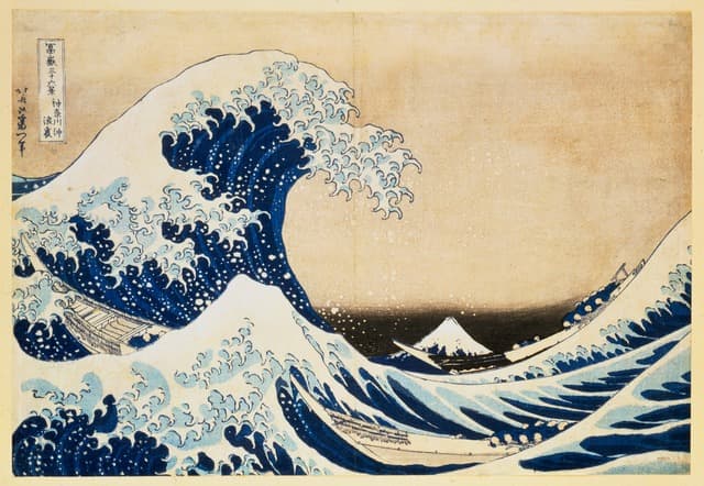 Hokusai’s Great Wave: a cresting blue wave above boats, with Mount Fuji in the distance