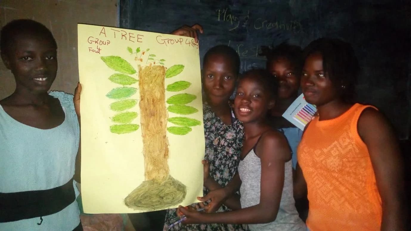 Girls’ Club participants presenting a tree they created together