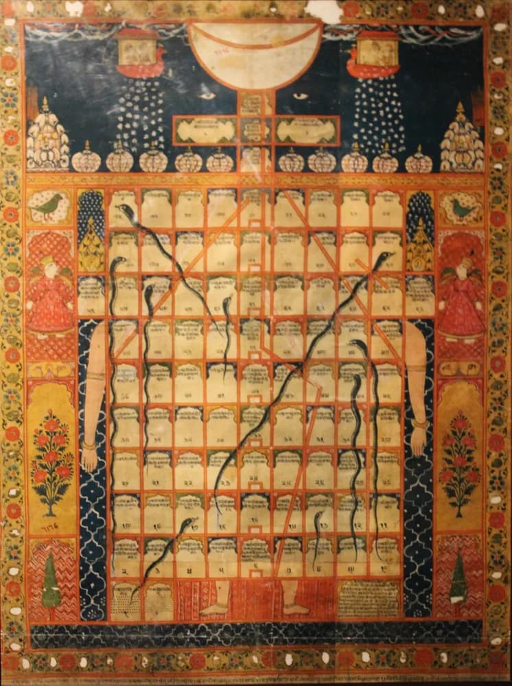 A painted gyan chaupar board with snakes, ladders, and religious imagery