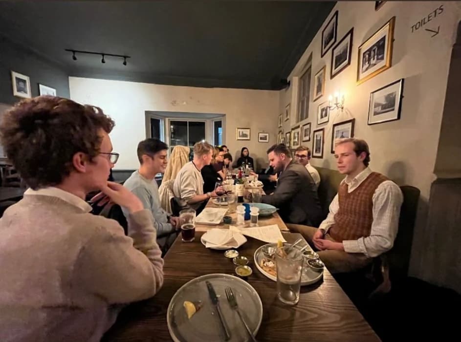 Kindled Spirits members gathered around a dinner table.