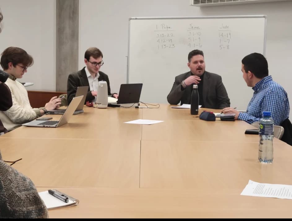 Participants in discussion across the seminar table.