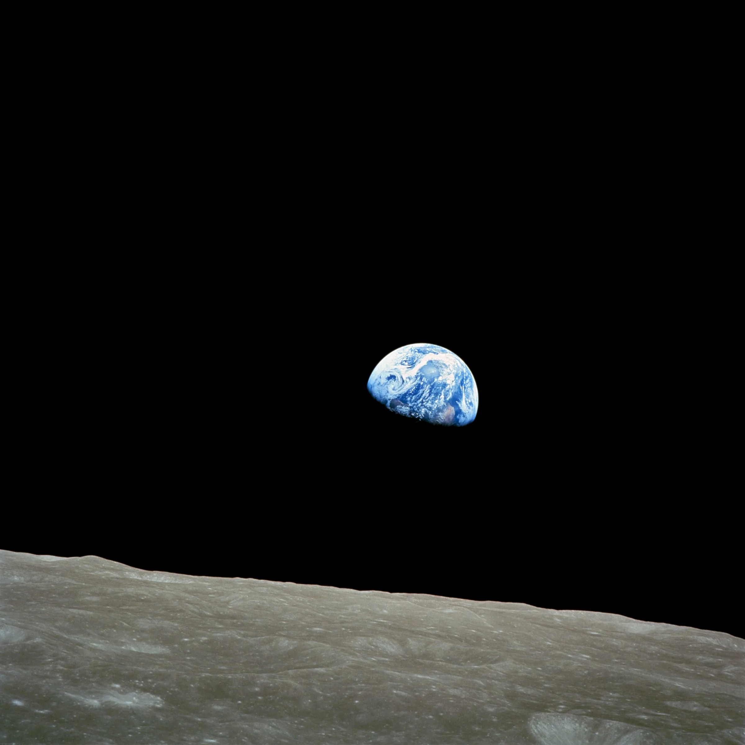Earthrise: the blue Earth above the grey horizon of the Moon