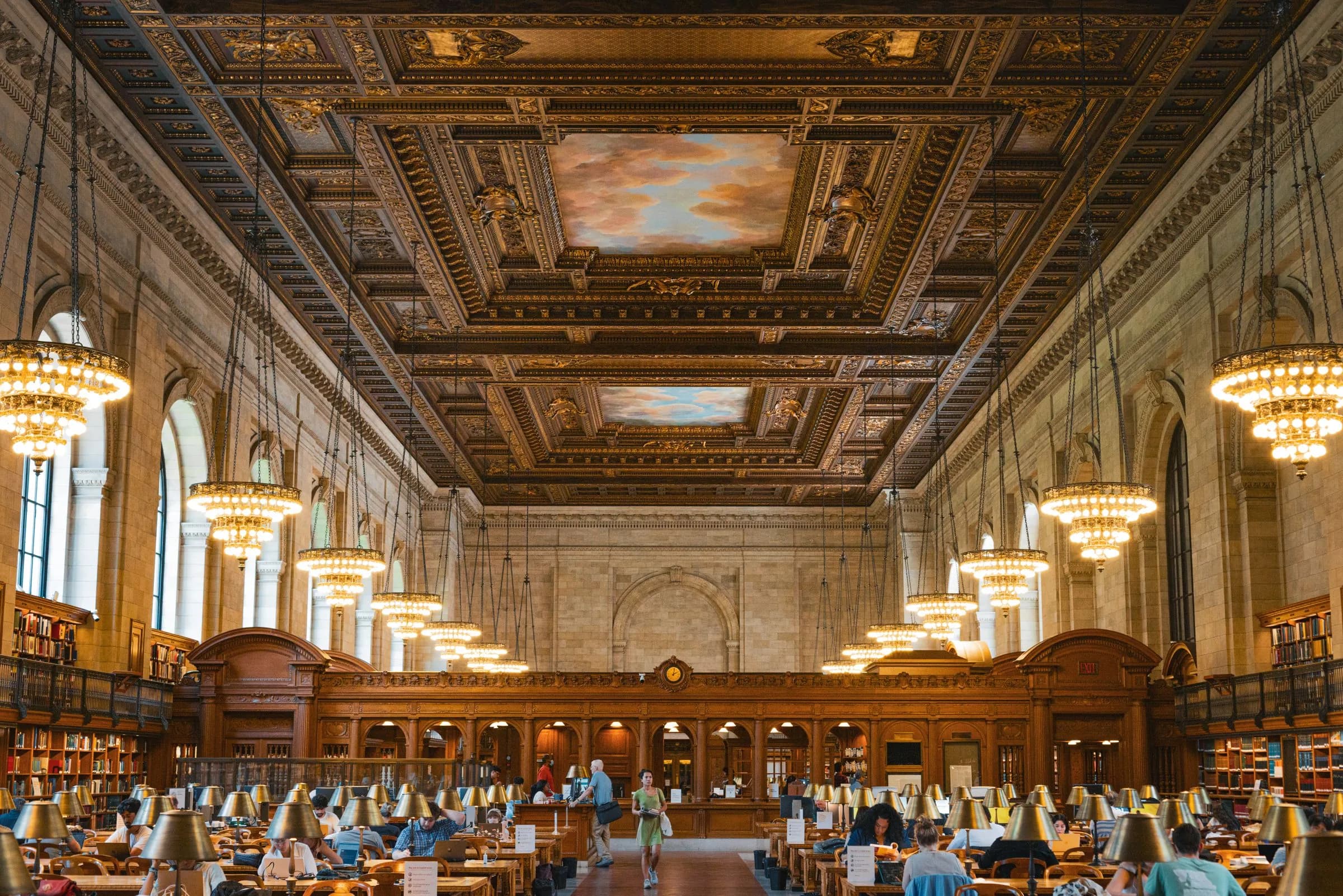 The Rose Main Reading Room of the New York Public Library, readers at long lamp-lit tables under a painted ceiling