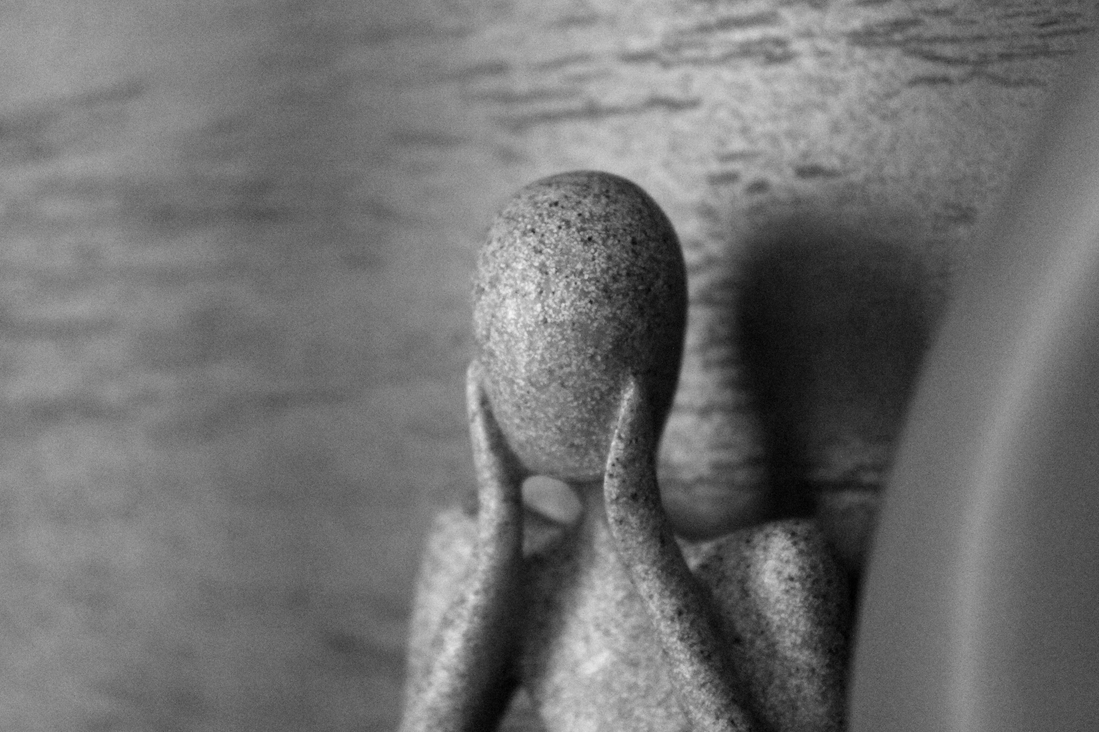 Black-and-white close-up of a statue.