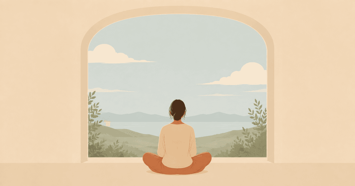 Person meditating beside a window overlooking mountains and a lake