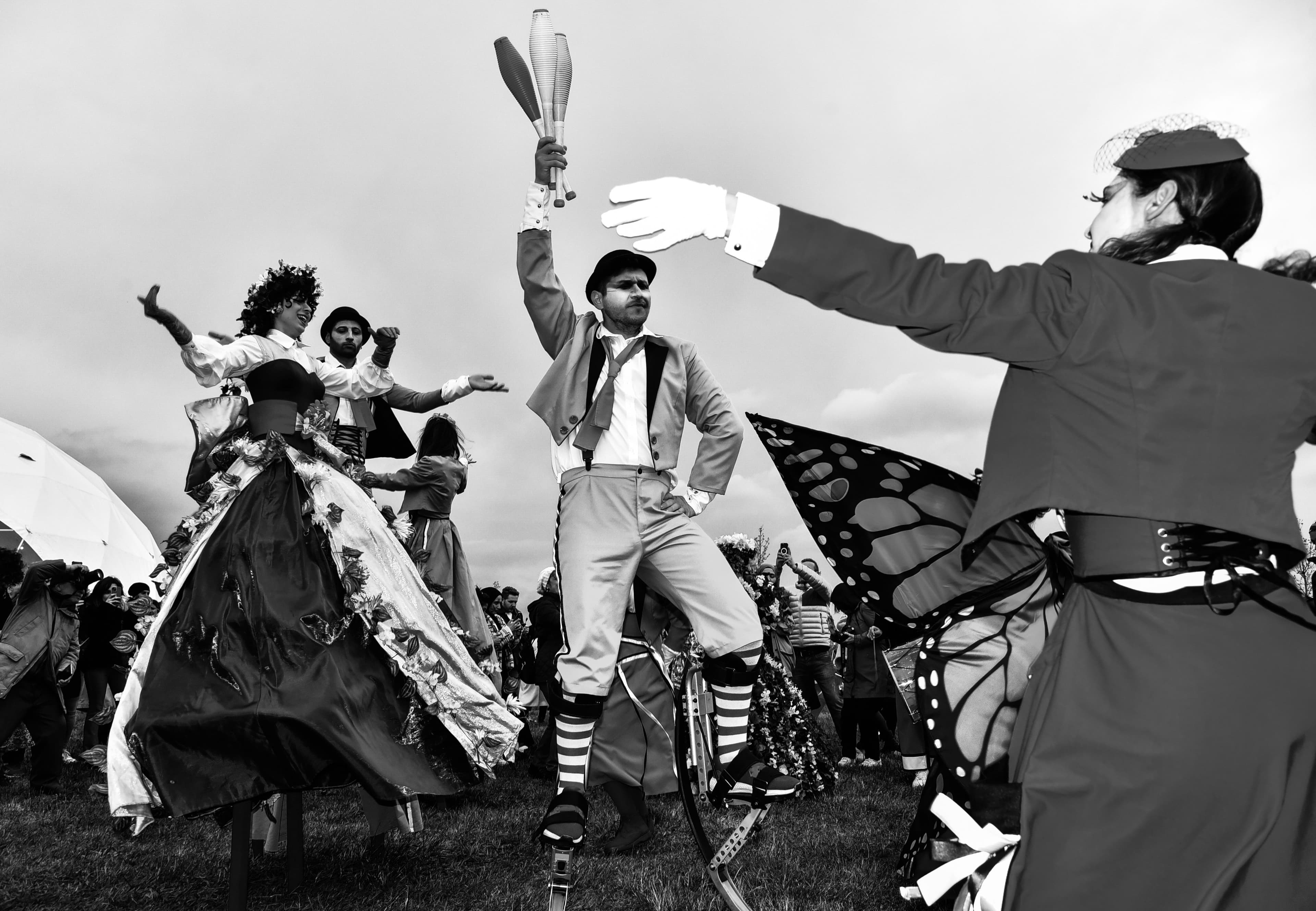 Performers in traditional clothing at an outdoor festival.